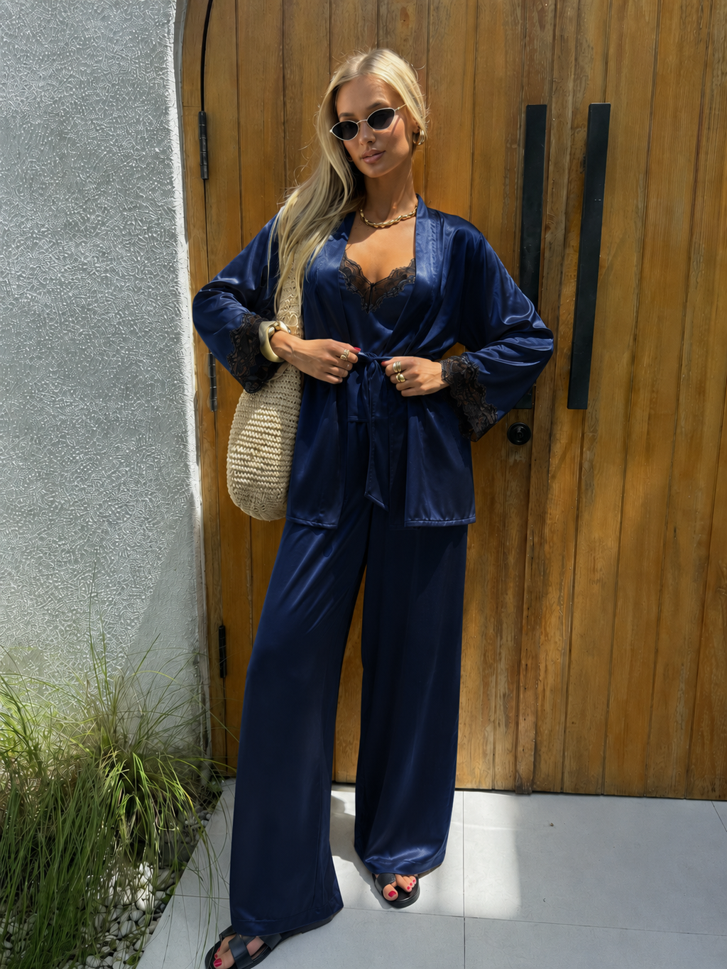 Navy Woman in a blue outfit standing in front of a wooden door.